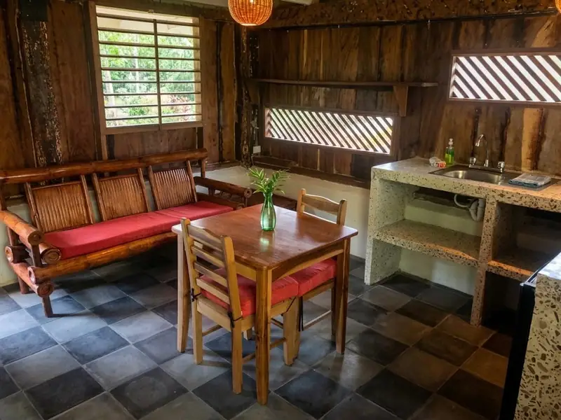 Wooden sitting and dining area of Cabaña Rústica